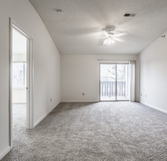 an empty living room with a ceiling fan and a window at Polo Run Apartments, Greenwood, IN, 46142