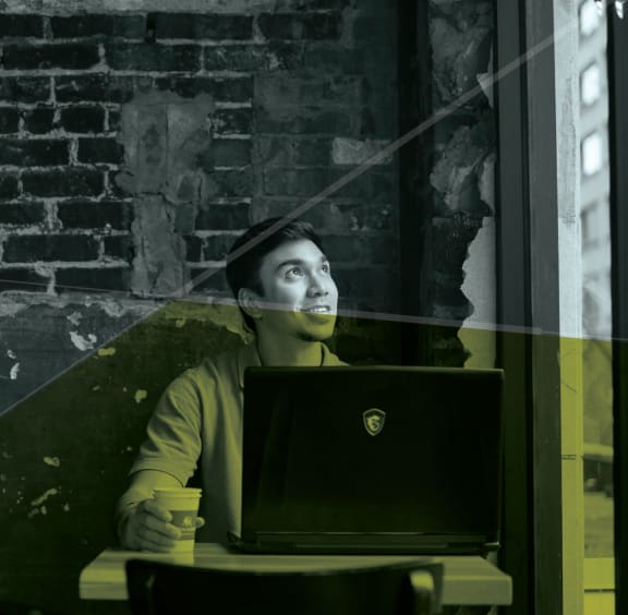 Guy working on laptop at 310 at Nulu Apartments-Student, Louisville Kentucky