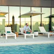 Man Relaxing on sun lounger at Scout Living, powered by Placemakr, Atlanta, GA