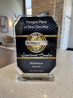 A glass award plaque for Paragon Place at Bear Claw Way.