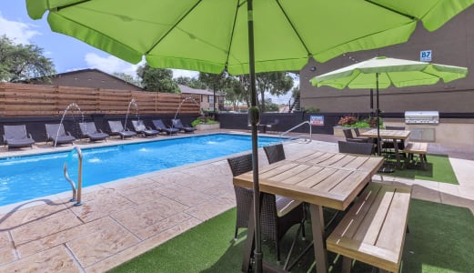Langtry Village pool with outdoor seating and umbrellas