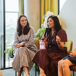 Two women sitting on chairs, one holding a microphone at Scout Living, powered by Placemakr, Atlanta