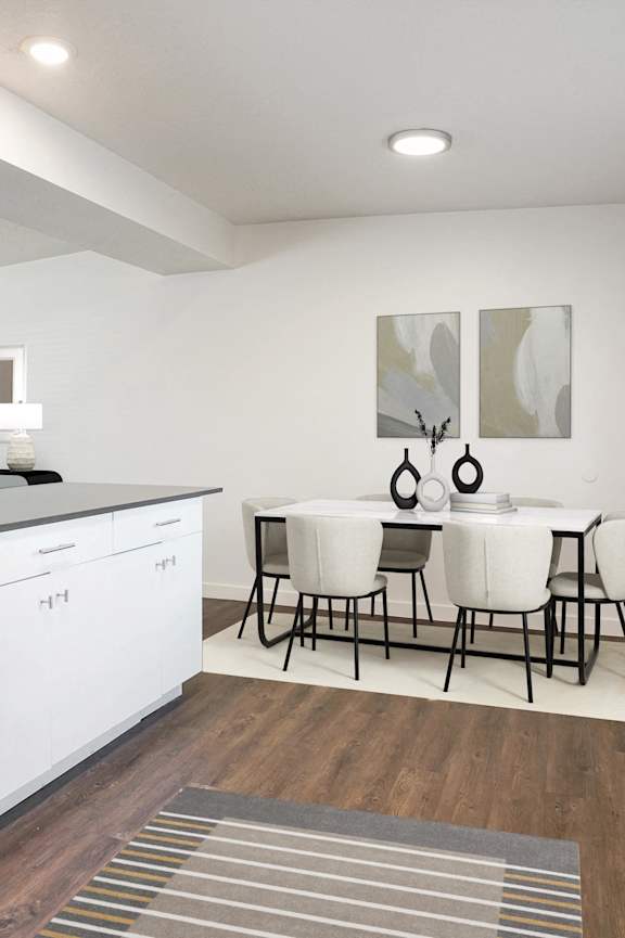 A modern kitchen with white appliances and a dining table set for four.