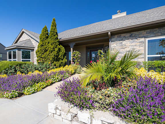 Front exterior of Cedar Crest Apartments clubhouse with landscaped grounds and main entrance.