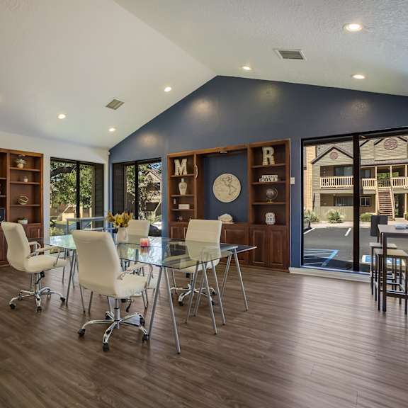 Business center with a glass table and chairs at Mountain Run Apartments, Albuquerque, NM