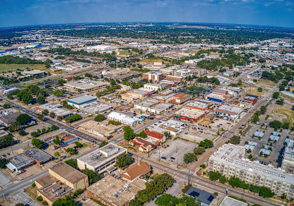 A cityscape with buildings and roads taken from an aerial perspective.