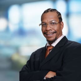 a man wearing a suit and a blue shirt