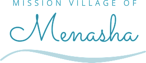 The image displays the name of a mission village, "Mission Village of Menasha" in cursive font.