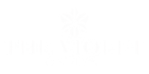 The image features a white graphic of a flower and text that reads "THE VIOLET ON WORK".