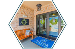 A blue mat with the word "ALLURE" on it is in front of a glass door.