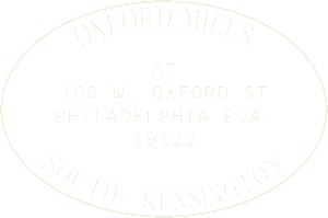 A black and white image of an oval label reading Oxford Mills at 100 W. Oxford St, Philadelphia P.A. 19122 South - Kensington.