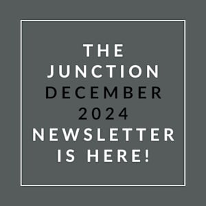 a white font on a grey background with the caption the junction december 2024 newsletter
