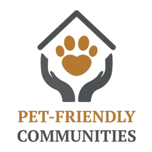a pet friendly communities logo with two hands holding a heart on a black background