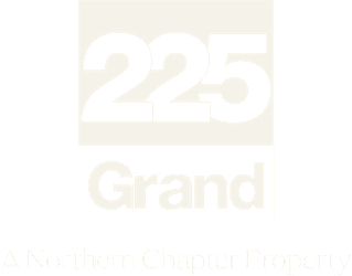 A beige sign with the number 225 and the word Grand on it.