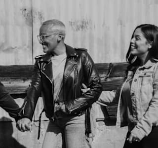 Two people holding hands and walking together.
