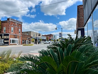 A street view with a building that has a sign that says "Tobacco".