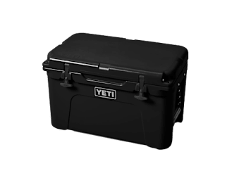 A black YETI cooler is shown against a black background.