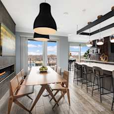 A modern kitchen with a dining table and chairs.