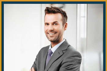 A man in a suit with his arms crossed.