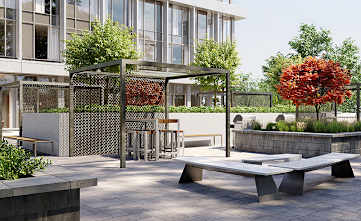 A modern outdoor seating area with a tree and a building in the background.