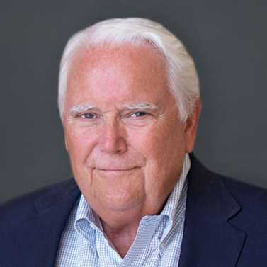 a man in a suit and tie smiling