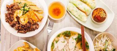 A variety of Asian dishes are displayed on a table.