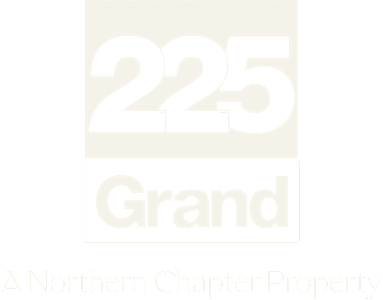 A beige sign with the number 225 and the word Grand on it.