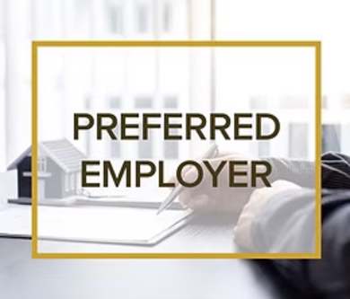A man is writing on a notepad with the words "PREFERRED EMPLOYER" displayed in a golden frame.