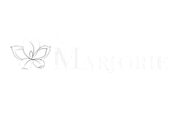 A logo with a flower and the word Marjorie.