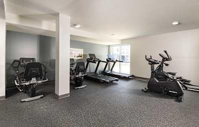 a rendering of a gym with people exercising on treadmills at Juniper Square 55+ Apartments, Arizona
