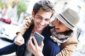 two people looking at a cell phone