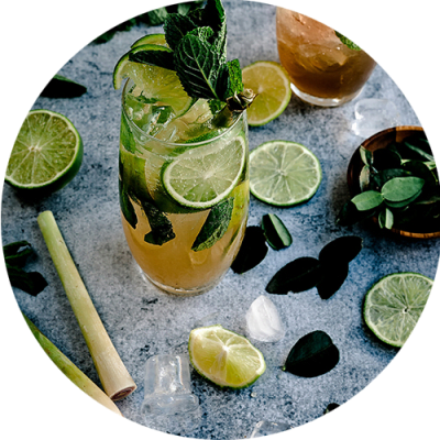 a cocktail with lime and mint on a table