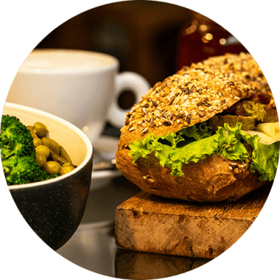 a sandwich and a cup of coffee on a table