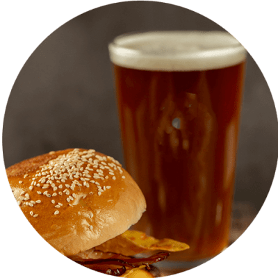a beer and a sandwich on a table
