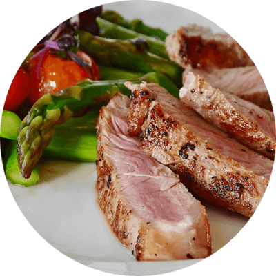 a white plate with meat and vegetables on it