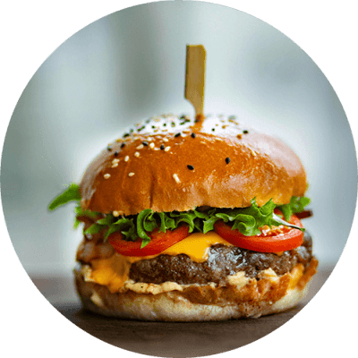 a cheeseburger on a white plate with a toothpick