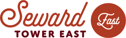 A logo with the words "Seward Towers East" in red.