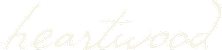 The image shows the word "heartwood" written in a cursive font.