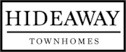 A black and white sign that says Hideaway Townhomes.