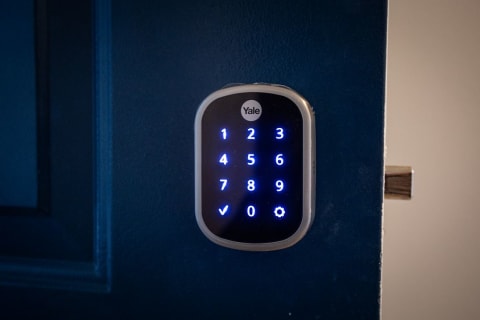 a blue door handle with a numeric keypad on it