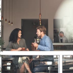 Couple drinking coffee in local cafe