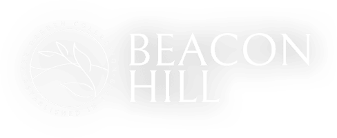 the logo for beacon hill is lit up at night