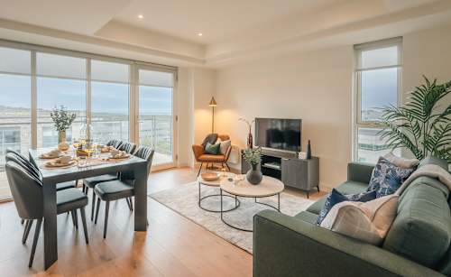 A modern living room with a dining table and a couch.