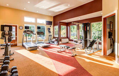a home gym with exercise equipment and windows at Madison Sierra Sun, Puyallup