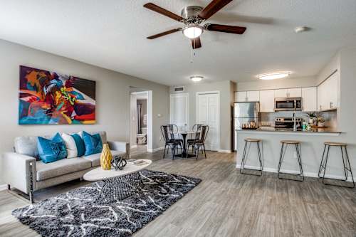 an open living room and kitchen with a couch and a table
