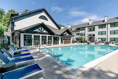a resort style pool with a building in the background