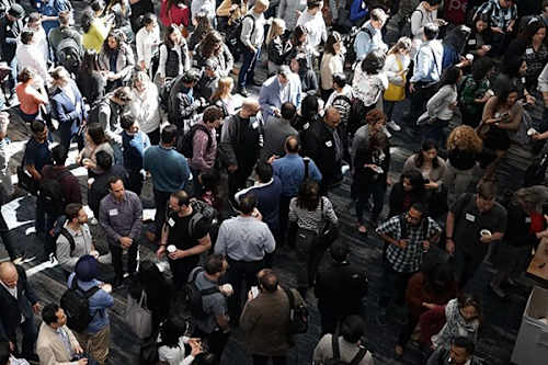 A large group of people are standing in a circle.