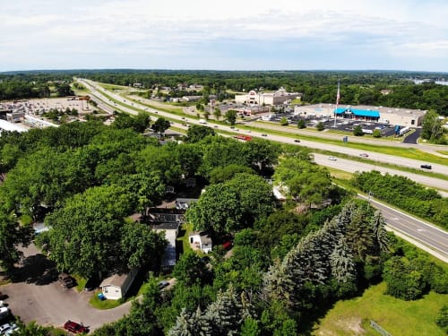 an aerial view of a city with highways and trees