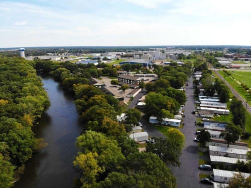 an aerial view of a city with a river and trees