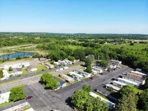an aerial view of a parking lot and trailers in a park